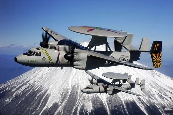 Two E-2C Hawkeyes conduct a flyby of Mount Fuji in Japan