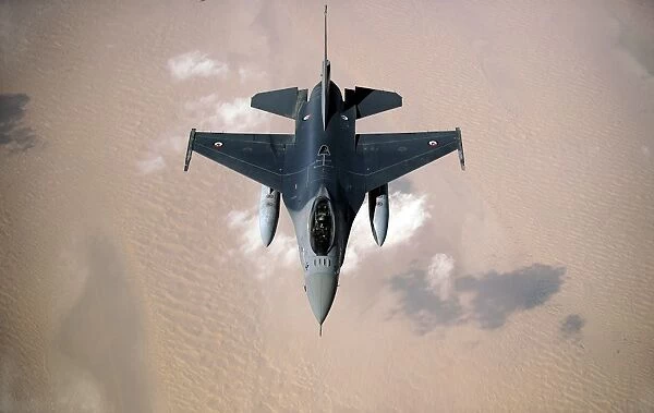 An Emirati F-16 disconnects from a KC-10A Extender after refueling during a multinational