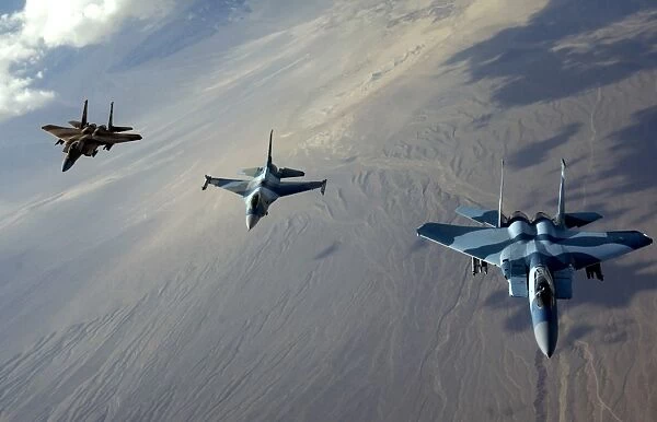 F-15 Eagles and a F-16 Fighting Falcon fly in formation