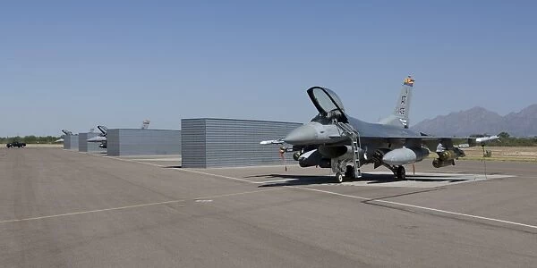 Three F-16s sit in the revetments at Davis-Monthan Air Force Base