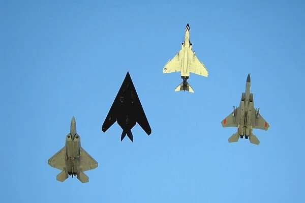 An F-22 Raptor, an F-117 Nighthawk, an F-4 Phantom and an F-15 Eagle in flight