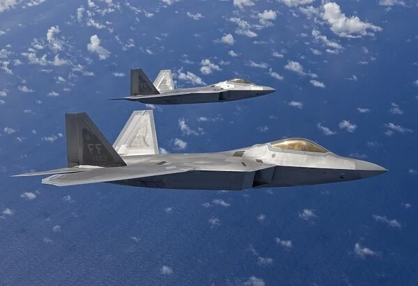 Two F-22 Raptors fly in formaton during a training mission
