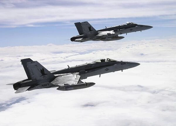Two F  /  A-18C Hornets fly over the Pacific Missile Range Facility
