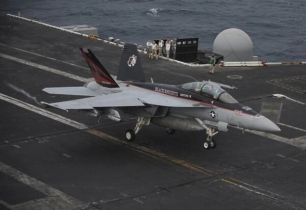 An F  /  A-18F Super Hornet lands on the flight deck of USS Nimitz