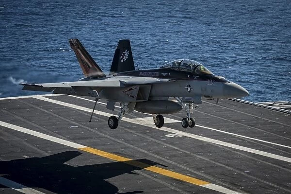 An F  /  A-18F Super Hornet lands on the flight deck of USS Nimitz