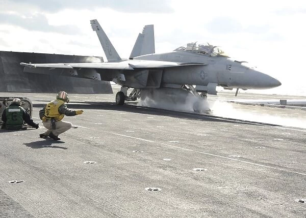 An F  /  A-18F Super Hornet launches off the flight deck of USS Enterprise