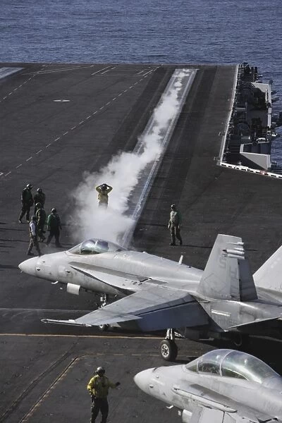An FA-18D Hornet taxis to the catapult aboard the aircraft carrier USS Ronald Reagan