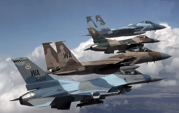 A flight of Aggressor F-15 and F-16 aircraft fly in formation