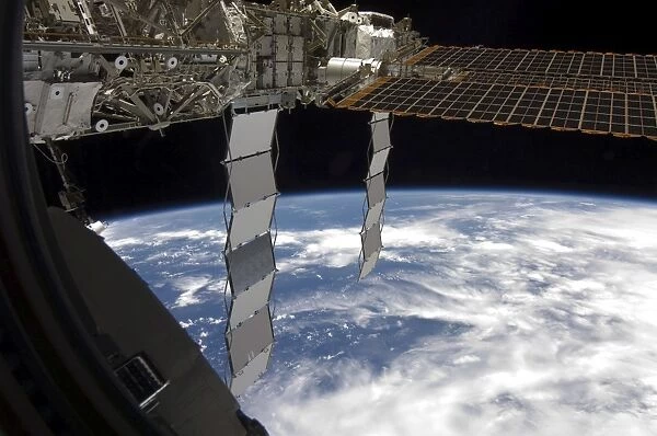 International Space Station backdropped againts a blue and white Earth