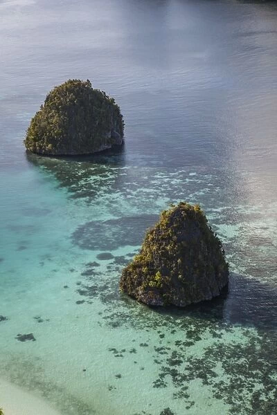 Limestone islands surrounded by a coral reef in Raja Ampat