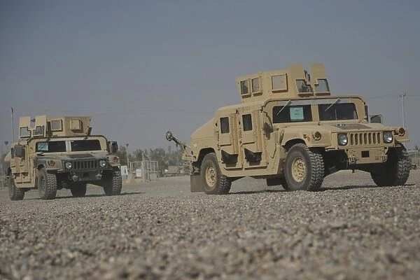 Two M1114 Humvee vehicles at Camp Taji, Iraq