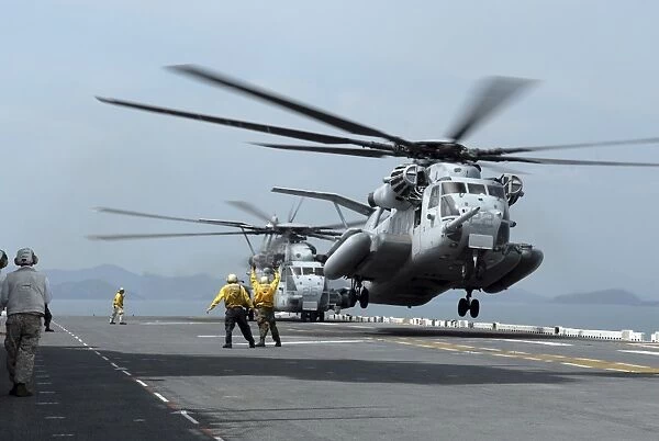 A Marine MH-53 helicopter takes off from the flight deck of USS Essex