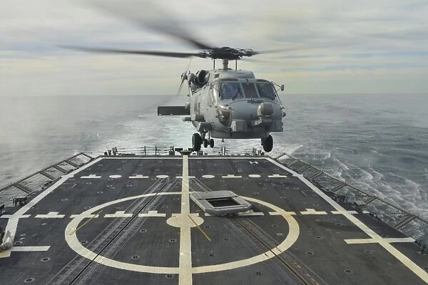 An MH-60R Sea Hawk helicopter lands aboard USS Halyburton