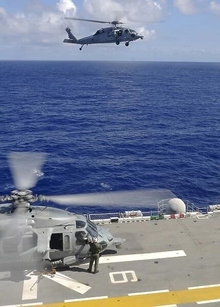 An MH-60S Sea Hawk helicopter approaches the flight deck of USS Essex