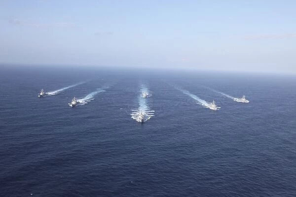 Military ships transit the Philippine Sea in formation