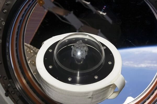 A moon rock floats aboard the International Space Station
