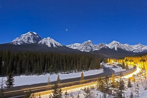 A moonlit nightscape over the Bow River and Morants Curve in Banff National Park, Canada