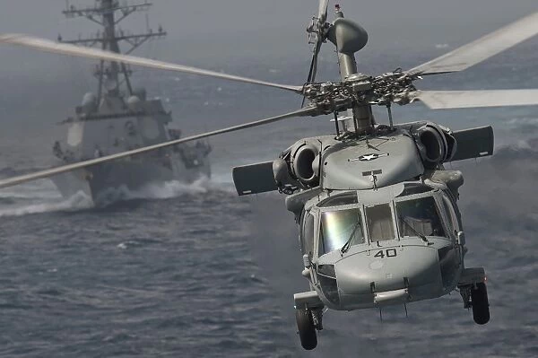 n MH-60S Knight Hawk delivers supplies to USS Carl Vinson