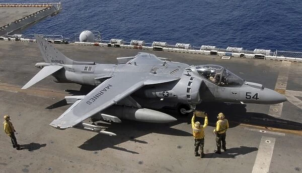 A pilot receives signals from air handlers before take-off during AV-8B Harrier flight