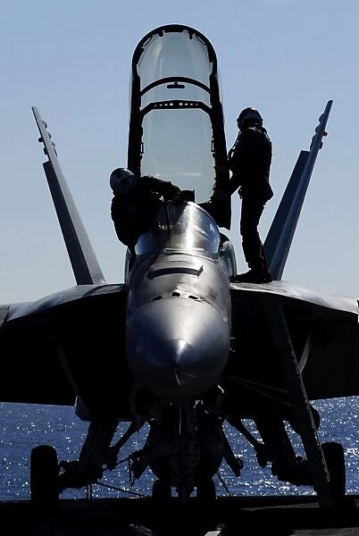Pilots conducts a pre-flight inspection on an F  /  A-18F Super Hornet
