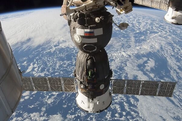 The Russian Soyuz TMA-11M spacecraft backdropped by Earth