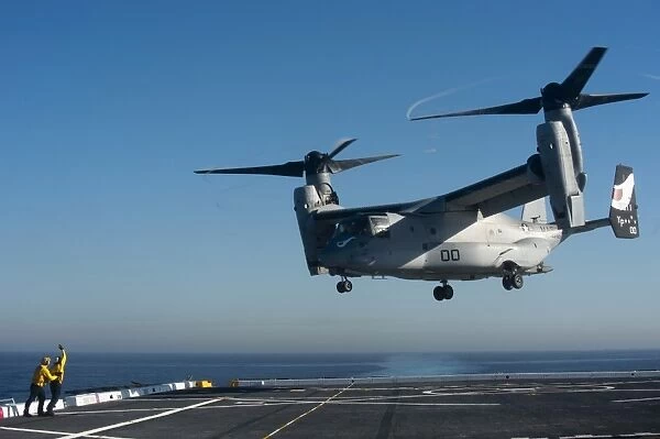 Sailors direct an MV-22 Osprey aboard USS San Diego