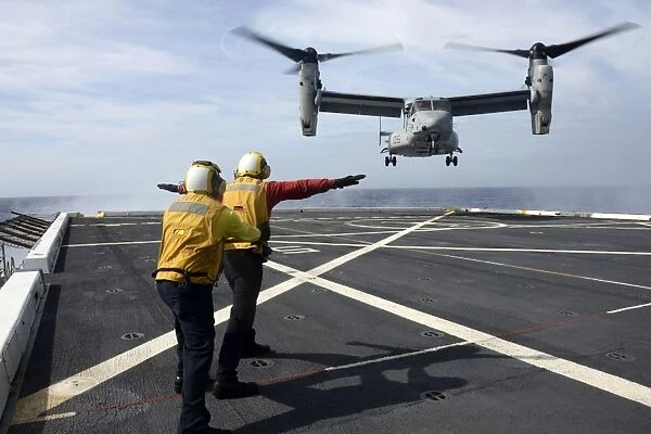 Sailors give an MV-22 Osprey flight directions