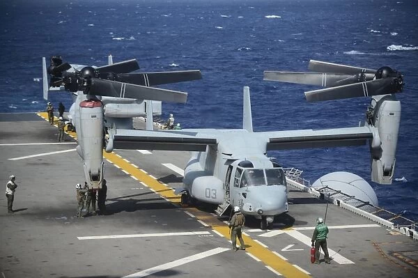 Sailors secure an MV-22 Osprey tiltrotor aircraft