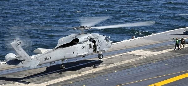 An SH-60F Sea Hawk helicopter lands aboard the aircraft carrier USS Harry S. Truman