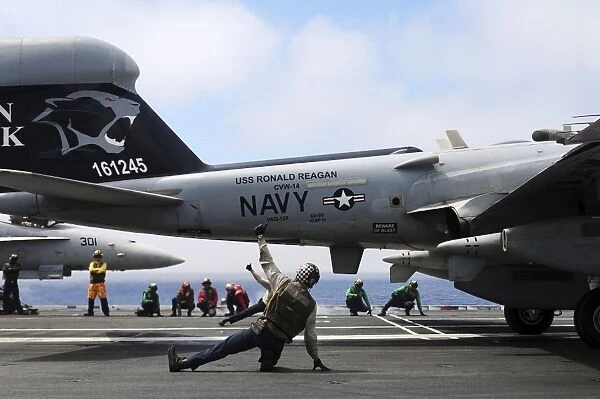 Shooters signal satisfactory final checks of an EA-6B Prowler before launch