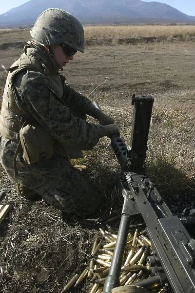 A soldier changes the barrel of an M2. 50 caliber machine gun