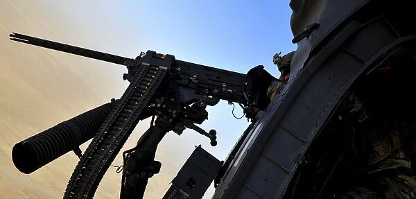 Soldier mans the. 50 caliber machine gun on a HH-60G Pave Hawk