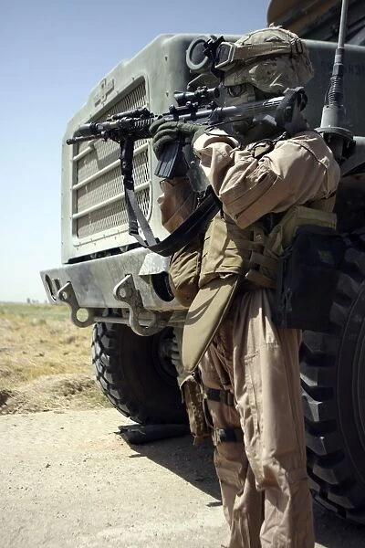A soldier provides security for Marines