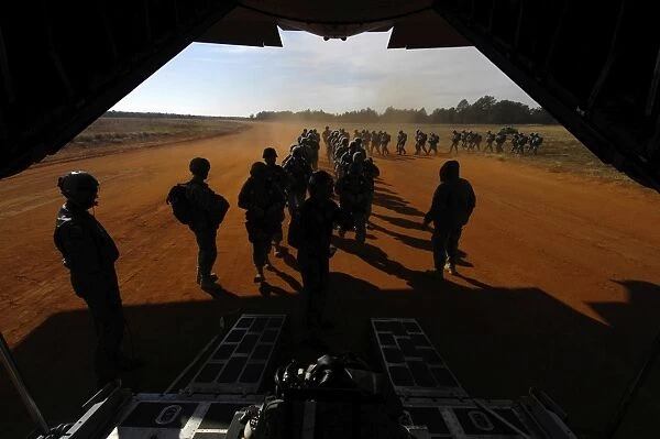 Soldiers board a C-130 Hercules during Operation Toy Drop