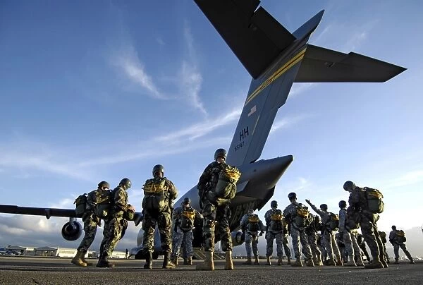 Soldiers prepare to board a C-17 Globemaster III