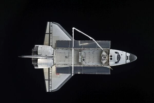 Space shuttle Atlantis backdropped against the blackness of space