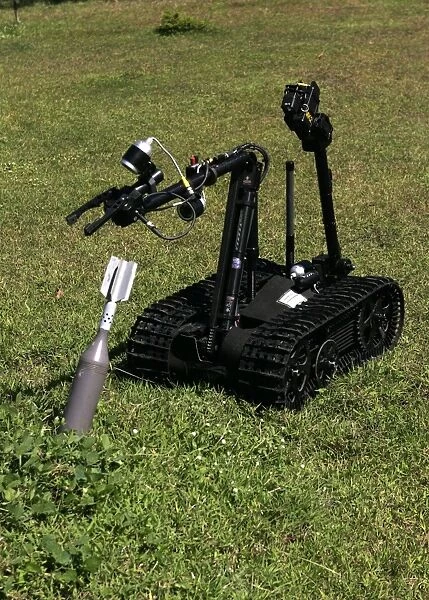 The Talon bomb disposal robot picks up an inert unexploded mortar round