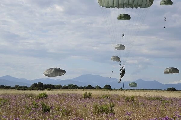 U. S. Army paratroopers descend to a drop zone in France