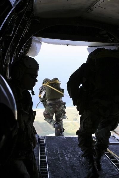 A U. S. Army Soldier performs a static-line jump from a