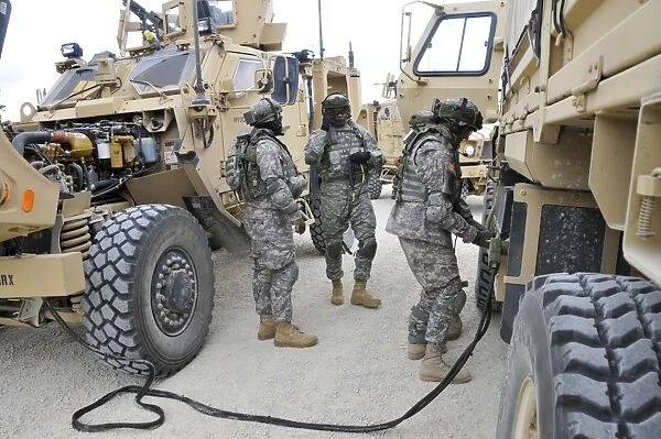 U. S. Army Soldiers jump start a light medium tactical vehicle