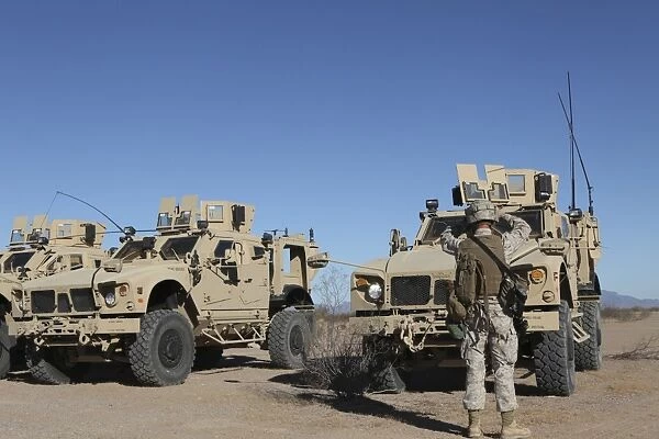 U. S. Marines guides a Mine Resistant Ambush Protected all-terrain vehicle