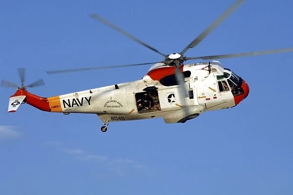 A UH-3H Sea King helicopter flies a search and rescue training mission
