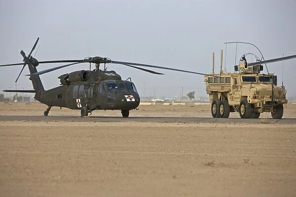 A UH-60 Black Hawk medevac helicopter and a RG-33 MRAP