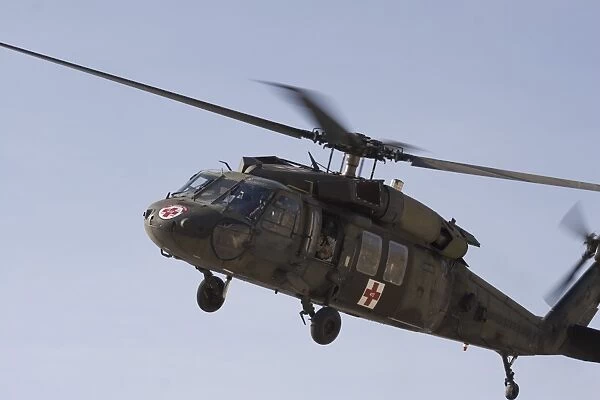 A UH-60 Blackhawk Medivac helicopter flies over Camp Warhorse