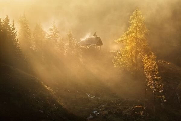 Alpine church in the morning fog