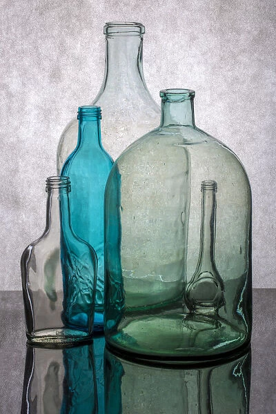 Still life with different transparent glass bottles