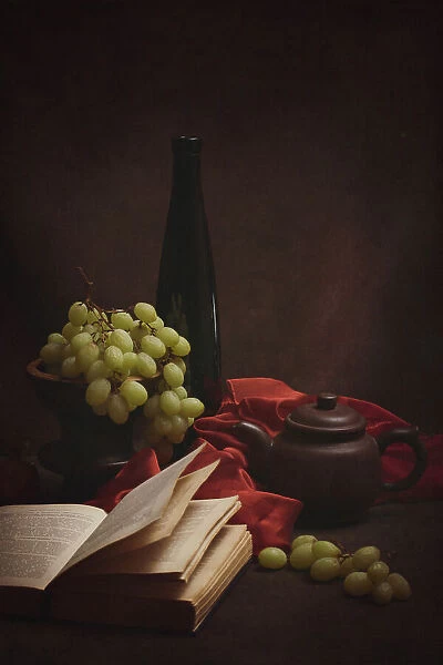 Still life with grapes, old books and a teapot