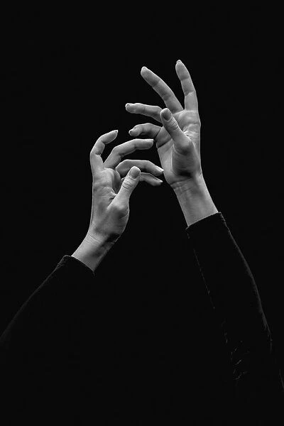 Prayer. Young beautiful ballerinas hands on a black background. Alexander Yakovlev