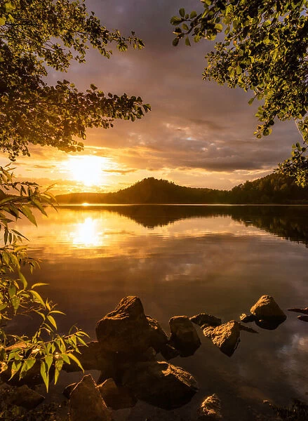 Sunset at a lake with a small mountain in the background