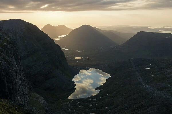 Sunset over Loch Coire Mhic Fhearchair from Beinn Eighe with the sky reflected in the water